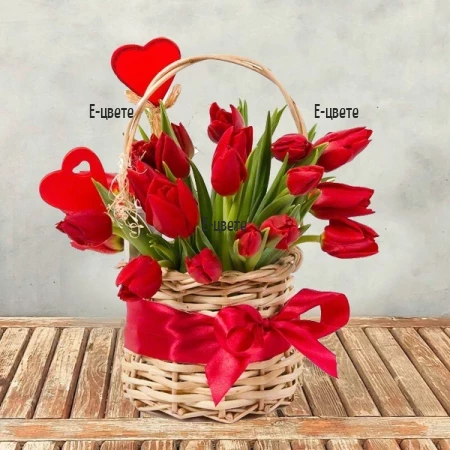 Send a basket with red tulips and greenery.