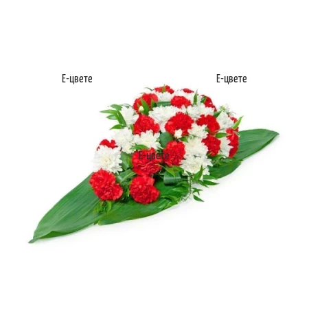 Funeral arrangement in white and red hues