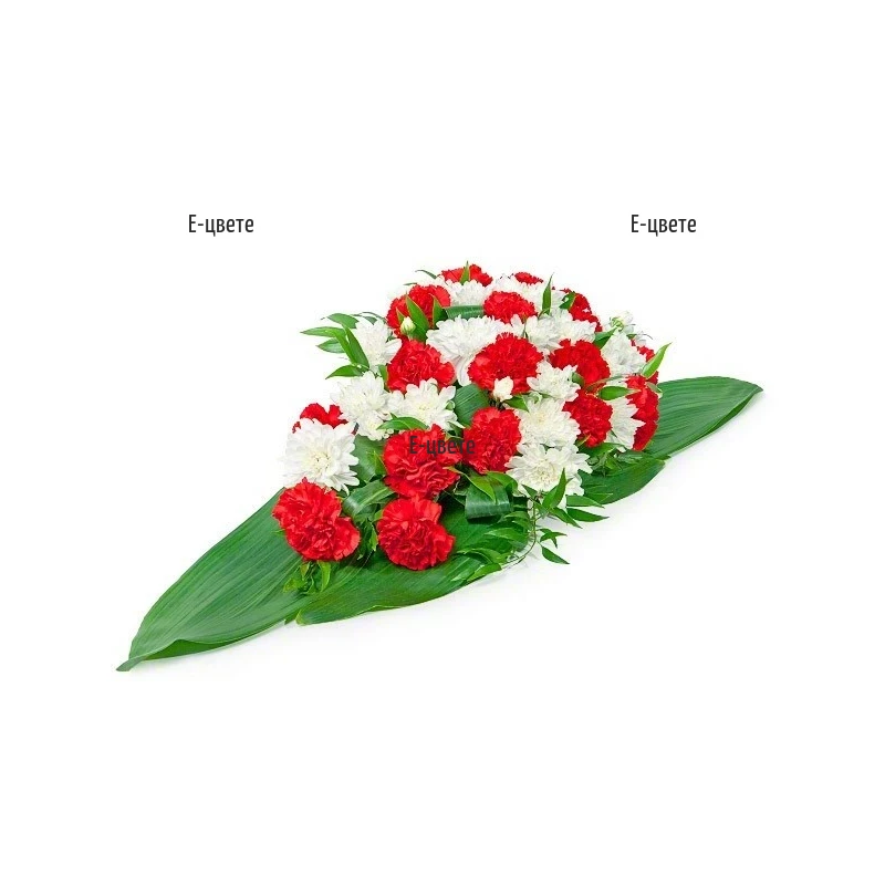 Funeral arrangement in white and red hues