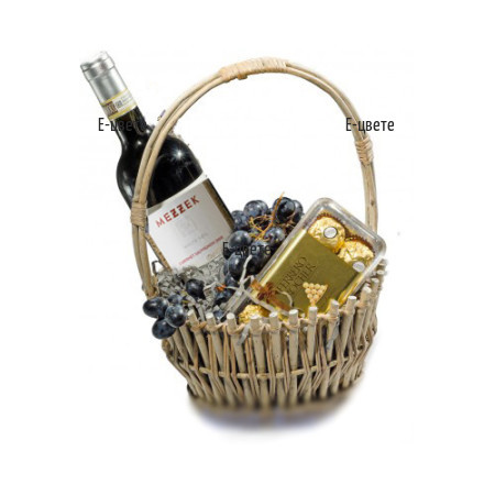 Send a basket with a bottle of wine, chocolates and fruits.