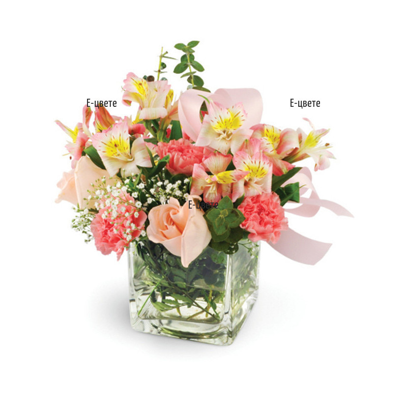 Send an arrangement of flowers and greenery in glass cube.