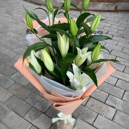 Send a boquet of white lilies and greenery by courier.