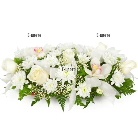Send an arrangement of white flowers and greenery.