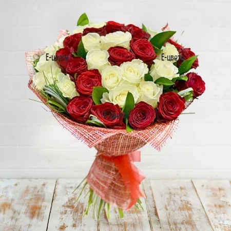 Send a luxurious bouquet of white and red roses.