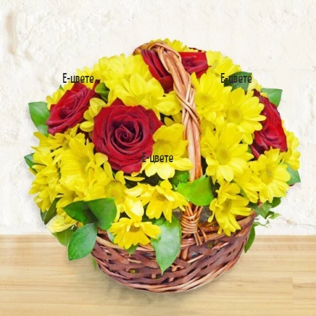 Basket with mixed flowers in red and yellow color