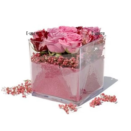 Send an arrangement of pink roses in a glass cube.