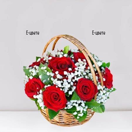 Basket with red roses and gypsophila