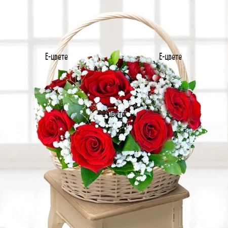 Basket with red roses and gypsophila