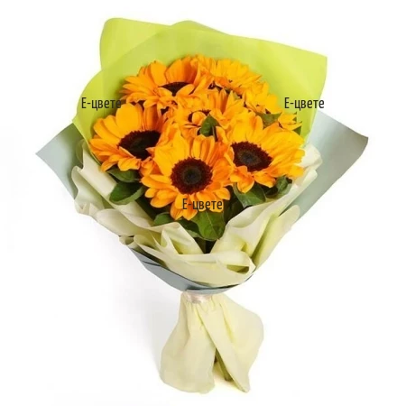 Summer bouquet of seven bright sunflowers wrap and ribbon