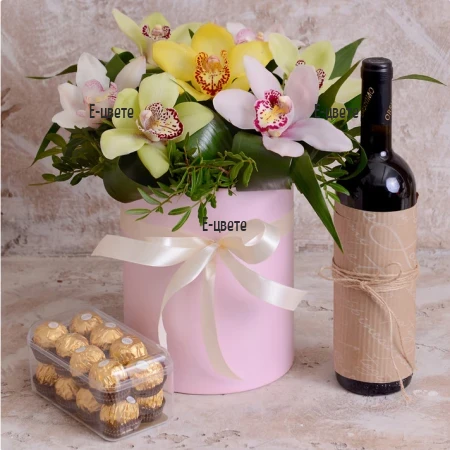 Flower delivery a box with orchids and gifts by courier