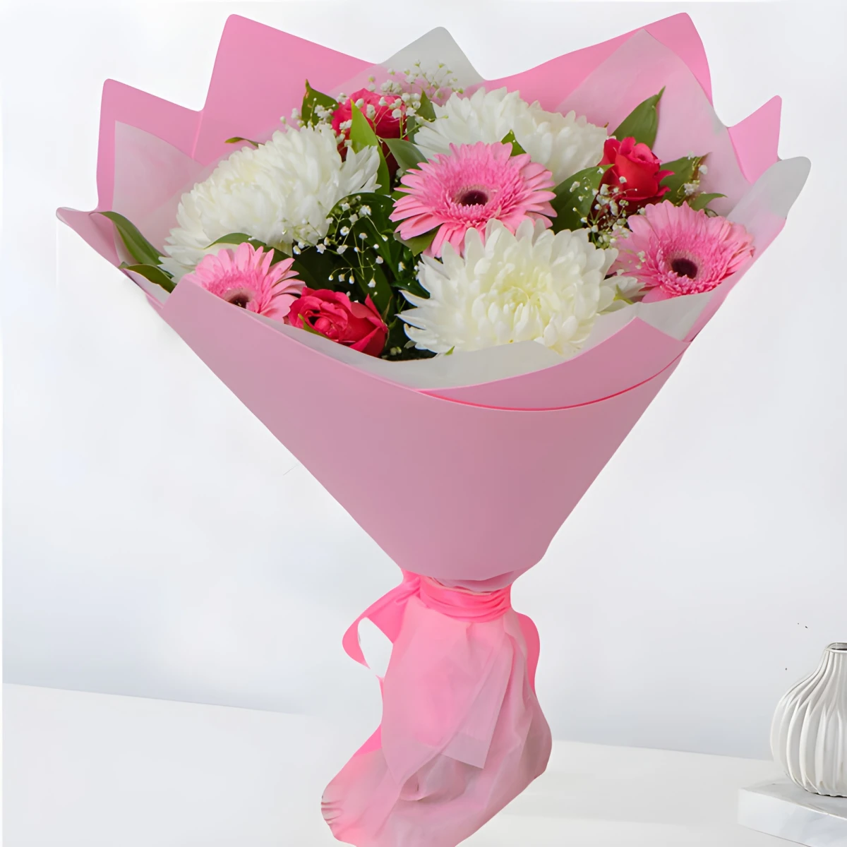 Send a bouquet in pink hues of roses and gerberas.