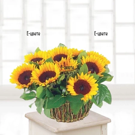 Send a basket with sunflowers and greenery.