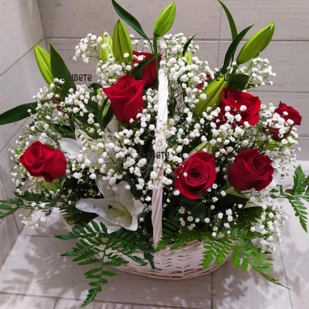 Send a flower basket with lilies, roses and greenery.