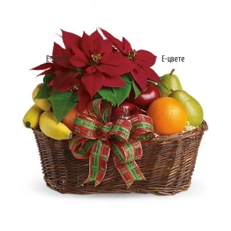 Send gift basket, arranged with fruits and Poinsettia﻿.