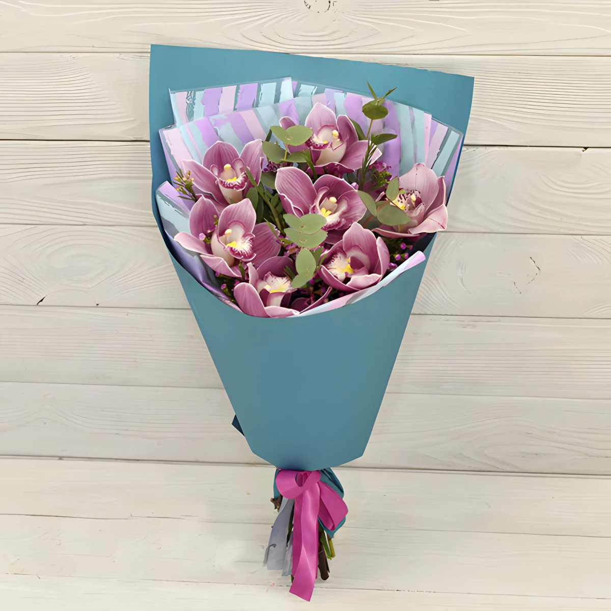 Send a bouquet of Cymbidium orchid and greenery.