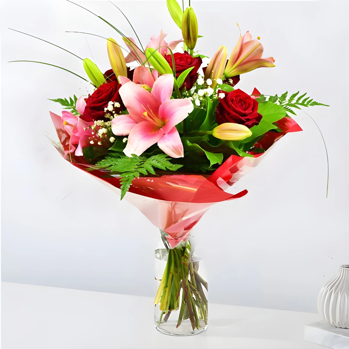 A beautiful and romantic bouquet of lilies roses and greenery