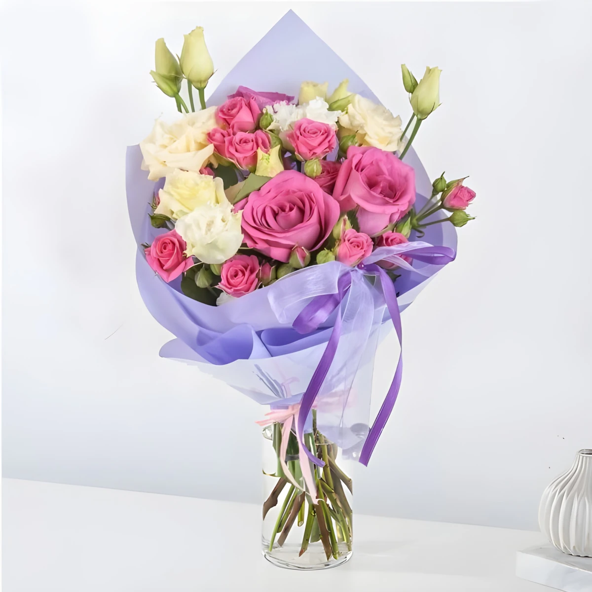 A delicate bouquet of roses and eustomas